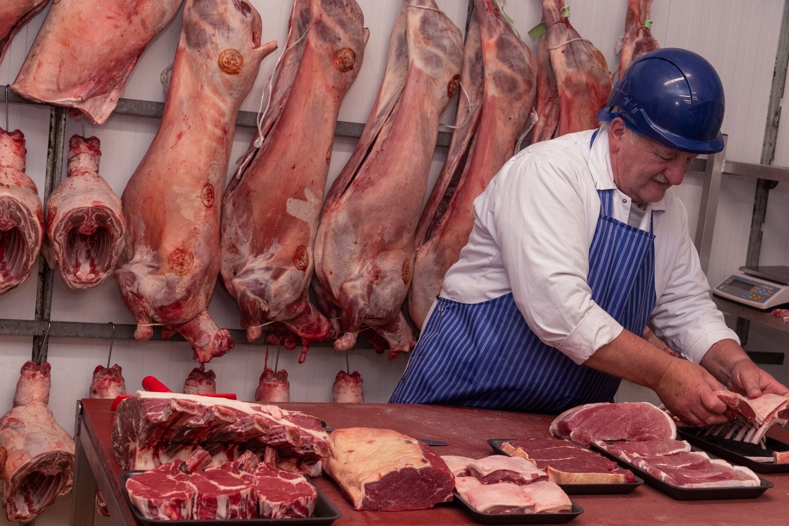 A Midland Foods butcher trimming meat at the Bromsgrove cutting bench